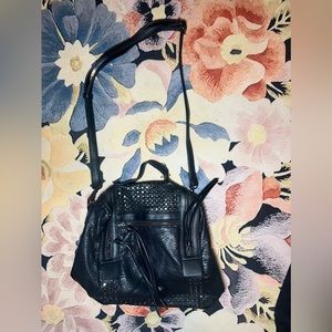 Black leather shoulder bag. Bag could also convert into a backpack